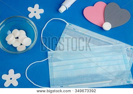 On A Blue Background Are: Medical Mask, Vitamin C, Antiviral Agents, Nasal Ointment, Two Hearts. The