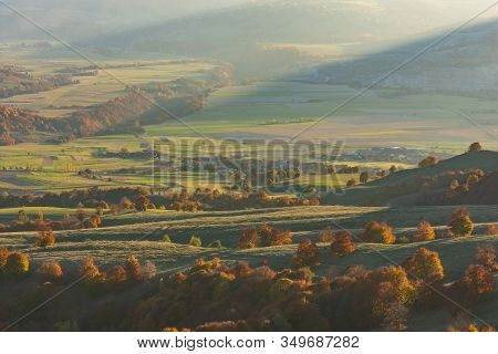 Beautiful Aerial View Of An Autumn Landscape Of A Green Valley With Colored Trees In The Golden Hour