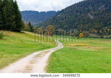 Landscape With Green Meadow, Multi Colored Trees, Mountain Range With Forest Nearby Menzenschwand, B