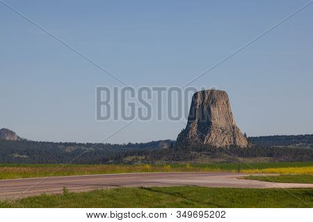 The Landscape Of Devils Tower National Monument In The Early Morning Sunshine.