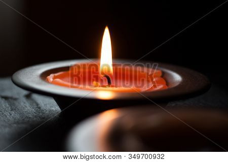 Candle light in tray on a black table