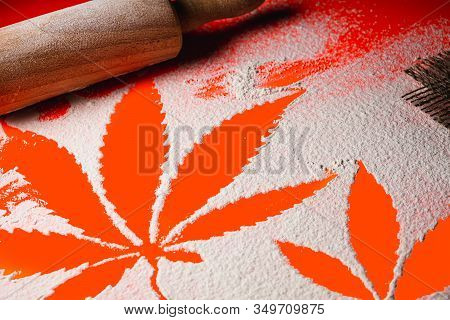 Cooking Cannabis Food. Trail Of Cannabis Leaf On White Flour On Lush Lava Color Table. Battledore. O