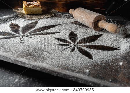 Cooking Cannabis Food. Trail Of Cannabis Leaf On White Flour On A Rust Table. Battledore. On A Burla
