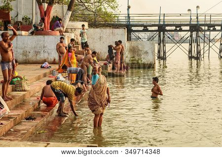 Kolkata, India - March 11, 2019:indian People Bathing In River Hooghly Or Ganga At Mallick Ghat In S