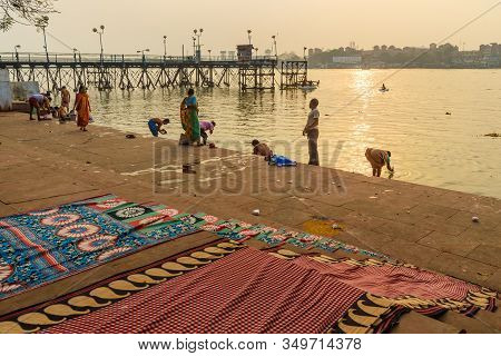 Kolkata, India - March 11, 2019:indian People Bathing In River Hooghly Or Ganga At Mallick Ghat In S