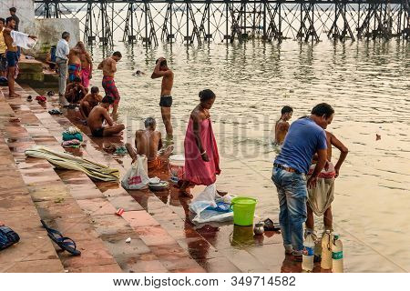 Kolkata, India - March 11, 2019:indian People Bathing In River Hooghly Or Ganga At Mallick Ghat In S