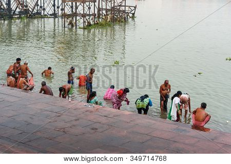 Kolkata, India - March 12, 2019:indian People Bathing In River Hooghly Or Ganga At Mallick Ghat In M
