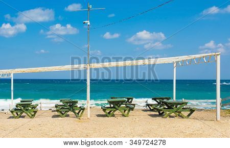 A Row Of Tables And Benches Outside A Beach Front Bar At Kilimli Bay, Near Agva, Sile, In North West