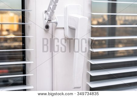A Handle And A Restrictor, Window Stopper Or Limiter On Pvc Double Glazed Window With Horisontal Alu