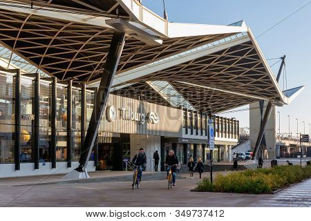 Tilburg, The Netherlands - December 04, 2019: Railway Station Tilburg With Passing Cyclists And Pede