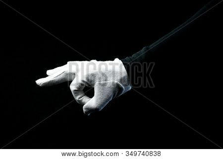 A Hand Wearing White Glove On Black Background Showing Zero Sign