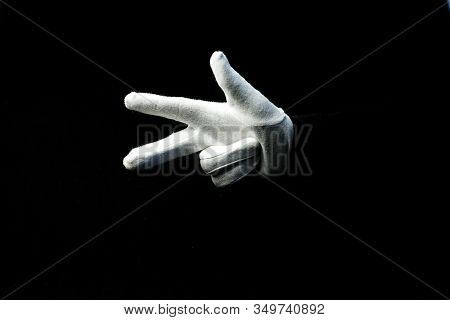 A Hand Wearing White Glove On Black Background Showing Number 3 Sign