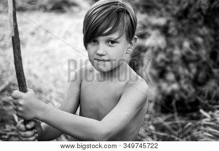 Fair-haired Kid Playing With Leaves And Looking At Camera. Sale For Entire Autumn Collection, Incred