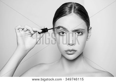 Young Beautiful Woman Does Natural Brow Makeup. Portrait Of Girl With Professional Makeup And Perfec