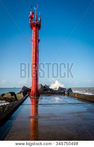 Pier At Corner Of Holland, With Basalt Blocks And Splashing And Foamy North Sea Water In The Winter 