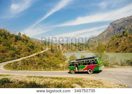 Bus On The Route To Annapurna Base Camp With Background Of The Mountain Forest And Nepali Local Trib