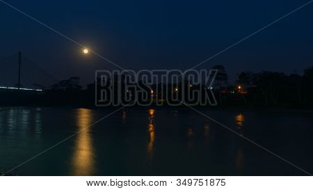 Night View With Yellow Moon Of The Bridge Over The Aguarico River Next To The City Of Lago Agrio Wit