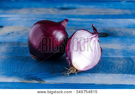 Red Onion On A Blue Background Close-up