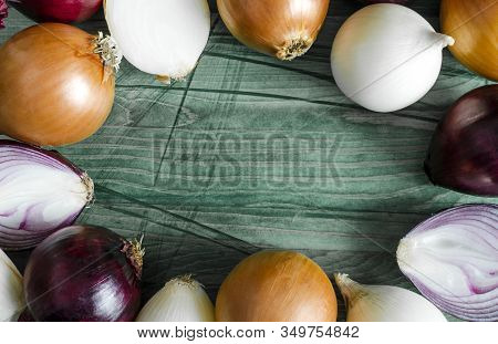 Red, White And Yellow Onions On A Wooden Background Close-up View From Above