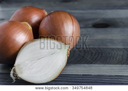 Large Yellow Onion Bulbs On A Blue Background Close Up