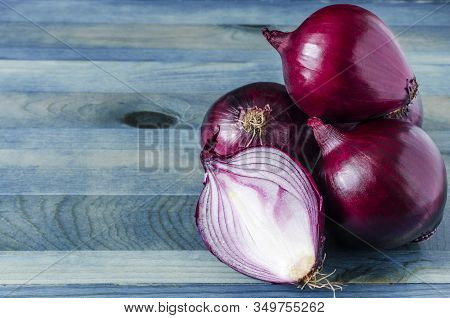 red onion on a blue background close-up
