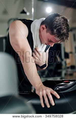 Sweaty Fit Young Man Exhausted After Running On Threadmill In Gym