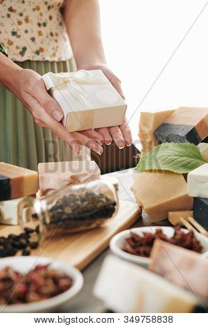 Hands Of Woman Holding Small Box With Soap Bar She Made At Home
