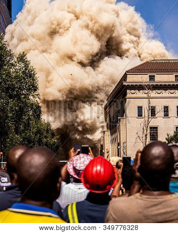 View Of An Implosion With Spectators Looking On
