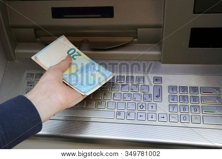 Young Boy Takes Money At Atm Machine In Europe