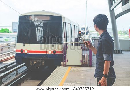 Bangkok Thailand, April 7,2019 : Asian Man Passenger Using Smartphone And Looking Bts In Train Stati
