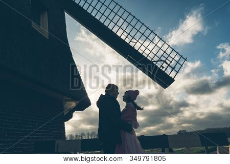 Loving Couple Man And Woman Face To Face Under The Mill In Holland