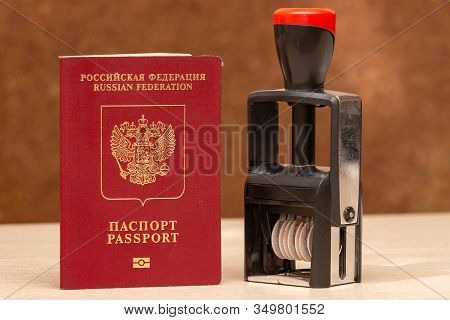Red Biometric Passport Of A Russian Citizen With A Border Date Stamper, Close-up. Inscription - Russ
