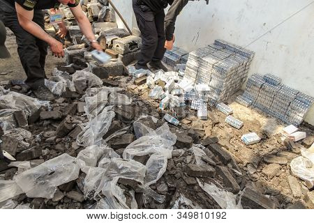 Krakovets, Ukraine - May, 2019: The Border Guard In Special Uniforms Throws Smuggled Cigarettes, Whi