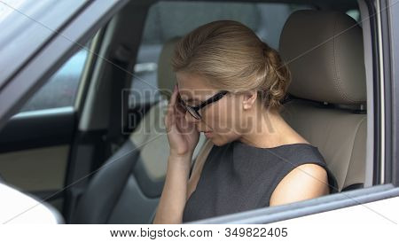 Woman In Car Suffering From Throbbing Headache, Stress And Overworking Result