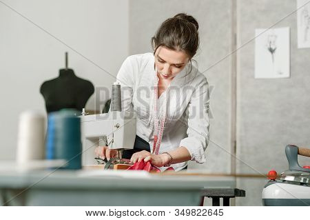 Dressmaker, Sews On Sewing Machine In Sempstress Studio