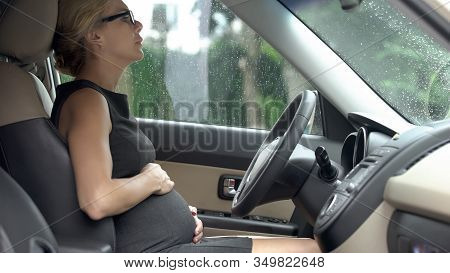 Pregnant Lady Sitting In Car, Touching Tummy, Feeling Better After Stomach Ache
