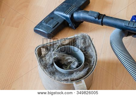 Vacuum Cleaner And Garbage Container. Full Vacuum Cleaner With Dust And Dirt On The Floor. Indoor Cl