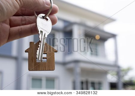 Landlord Unlocks The House Key For New Home.  Real Estate Agents, Sales Agents Concept.