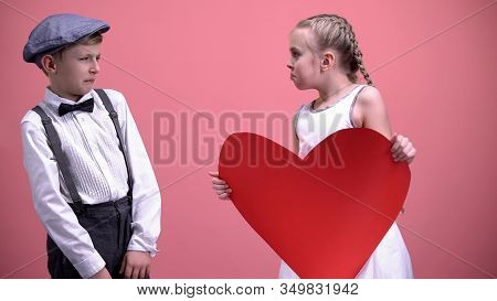 Funny Female Kid With Paper Heart Trying To Kiss Young Boy Male Kid Recoils Date