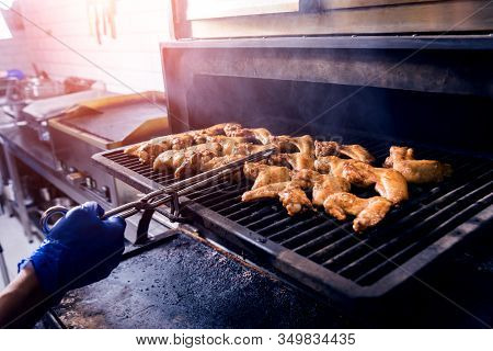Fried Chiken Wings At Grill Barbecue. Restaurant.