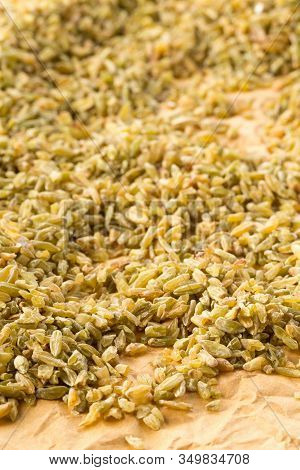 Heap Of Uncooked, Raw Freekeh Or Firik, Roasted Wheat Grain, On Brown Packing Paper Background With 