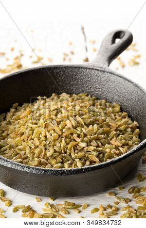 Uncooked, Raw Freekeh Or Firik, Roasted Wheat Grain, In Metal Pan On White Rustic Table Background W