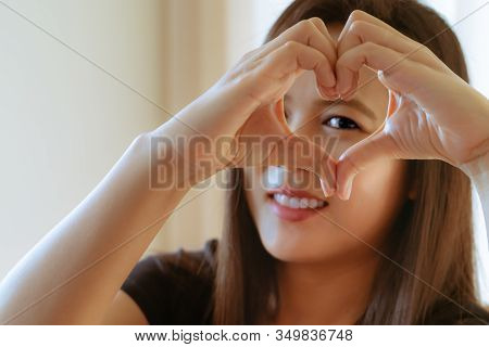 Happy Woman Day. Beautiful Happy Woman Holding Heart Shaped Hands. Healthy Eyes And Vision.