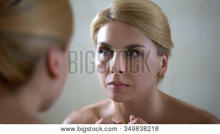 Portrait Of Beautiful Lady Looking At Mirror Reflection, Anti-aging Cream Effect