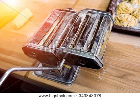 Chef Rolling Dough With A Pasta Machine. Pasta Maker Machine.