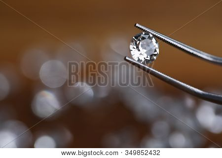 Painstaking Jewelry Work, Looking At Diamond. Master Holds Small Gem With Tweezers. In Foreground, T