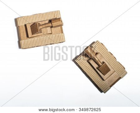 Two Toy Tanks Made By Children From Corrugated Cardboard Are Fighting. Toy Cardboard Tanks Isolated 