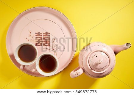 Teapot and cups used in traditional Chinese wedding ceremony with chinese sign meaning happinese. Translation: Double Happiness