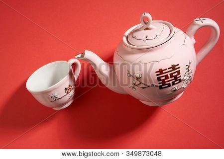 Teapot and cups used in traditional Chinese wedding ceremony with chinese sign meaning happinese. Translation: Double Happiness