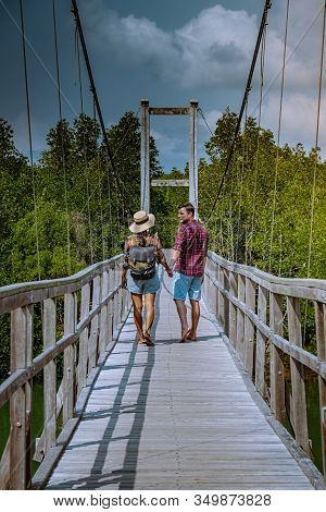 Muko Chumphon National Park, Thailand , Couple Walking On Wooden Deck In The Park With Trees And Man